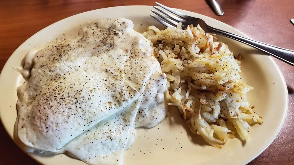 Biscuit & Gravy with Two Eggs on Top and Hash Browns